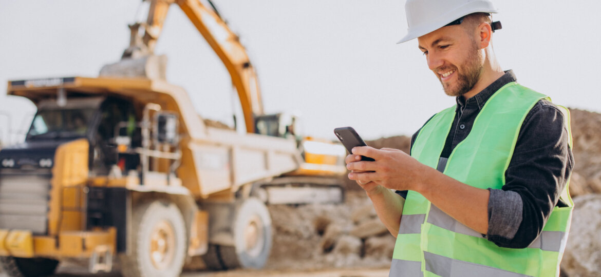 Male worker with bulldozer in sand quarry